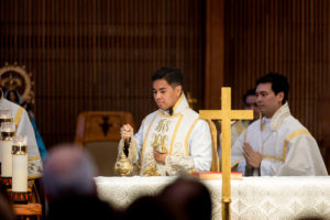 Father Jerick Alenton dispenses incense around the altar during his first Mass at his home parish of St. Clare of Assisi Church in Santa Clarita on May 31. (Joe Garcia III)