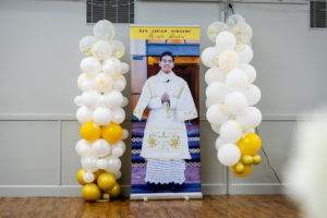 Balloons surround a photo of Father Jerick Alenton during his first Mass at his home parish of St. Clare of Assisi Church in Santa Clarita on May 31. (Joe Garcia III)