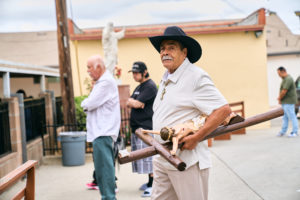 A man carries a cross during a special Mass at Nuestra Señora de Guadalupe Church in East LA on Sunday, June 28, to pray for victims of the Venezuela earthquakes. (John Geronilla)