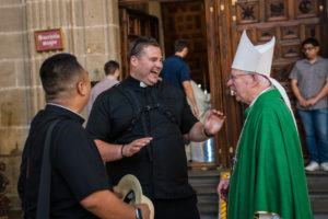 Archbishop José  H. Gomez has a laugh with LA Vocations priests Father Louie Reyes, left, and Father Thomas Green at a Mass at the Mexico City Metropolitan Cathedral on July 10. (Isabel Cacho)