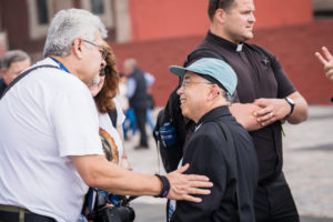 Pilgrims from the Archdiocese of Los Angeles speak to LA Auxiliary Bishop Brian Nunes outside the Basilica of Our Lady of Guadalupe in Mexico City on July 11. (Isabel Cacho)