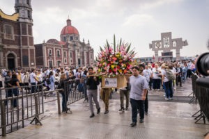 Pilgrims from the Archdiocese of Los Angeles carry flowers into the Basilica of Our Lady of Guadalupe in Mexico City for Mass on July 11. (Isabel Cacho)
