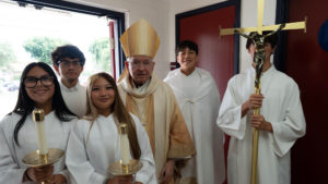 Archbishop José H. Gomez poses with altar servers following the Welcome Back Mass on Aug. 5 at Cantwell-Sacred Heart of Mary High School in Montebello. (Poncho Romero)
