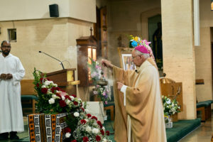 Archbishop José H. Gomez dispenses incense over the cremated remains of Deacon Hosea Alexander during the Aug. 14 funeral Mass at Holy Name of Jesus Church in Los Angeles. (John Geronilla)