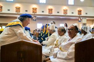 Attendees greet each other during the Aug. 14 funeral Mass for Deacon Hosea Alexander at Holy Name of Jesus Church in Los Angeles. (John Geronilla)