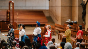 Attendees dressed in cultural, ethnic, and religious clothing participate in the 