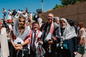 Attendees dressed in cultural, ethnic, and religious clothing pose following in the 