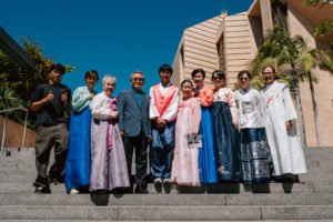 Attendees dressed in cultural, ethnic, and religious clothing pose following in the 