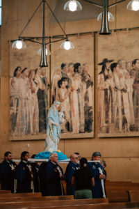 A statue of the Virgin Mary carrying Jesus is carried into the 