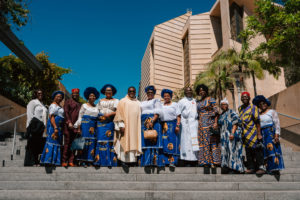 Attendees dressed in cultural, ethnic, and religious clothing pose following in the 