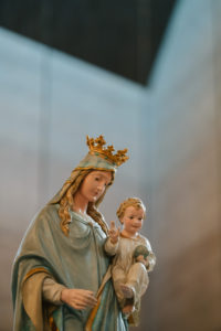 A statue of the Virgin Mary carrying Jesus is carried into the 