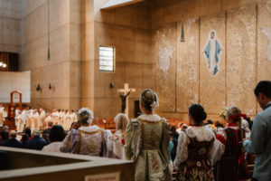 Attendees dressed in cultural, ethnic, and religious clothing participate in the 