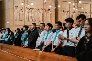 Attendees dressed in cultural, ethnic, and religious clothing participate in the 