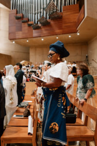 Attendees dressed in cultural, ethnic, and religious clothing participate in the 