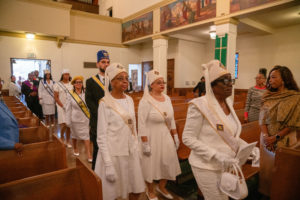 The Ladies Auxiliary of Peter Claver process in during the Sept. 6 Mass of Thanksgiving at Transfiguration Church for Greg Warner Sr.’s election as supreme navigator of the national Knights of Peter Claver. (John Rueda)