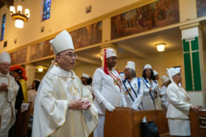 Auxiliary Bishop Brian Nunes processes in during the Sept. 6 Mass of Thanksgiving at Transfiguration Church for Greg Warner Sr.’s election as supreme navigator of the national Knights of Peter Claver. (John Rueda)