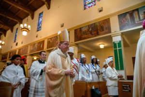 Archbishop José H. Gomez processes in to begin the Sept. 6 Mass of Thanksgiving at Transfiguration Church for Greg Warner Sr.’s election as supreme navigator of the national Knights of Peter Claver. (John Rueda)