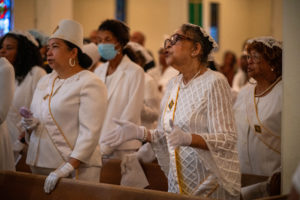 Attendees pray during the Sept. 6 Mass of Thanksgiving at Transfiguration Church for Greg Warner Sr.’s election as supreme navigator of the national Knights of Peter Claver. (John Rueda)