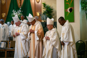 Bishops and priests bow during the Sept. 6 Mass of Thanksgiving at Transfiguration Church for Greg Warner Sr.’s election as supreme navigator of the national Knights of Peter Claver. (John Rueda)