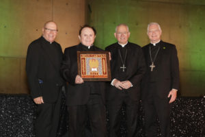 Msgr. Francis Hicks, second from left, holds his award after being honored at the 2026 St. John's Seminary Gala at the Cathedral of Our Lady of the Angels on Sept. 19. (Belle N’ Beau Photography)