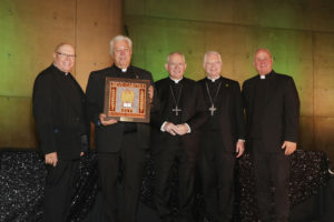 Father Steven Sallot, a retired priest in the Diocese of Orange, second from left, holds his award after being honored at the 2026 St. John's Seminary Gala at the Cathedral of Our Lady of the Angels on Sept. 19. (Belle N’ Beau Photography)