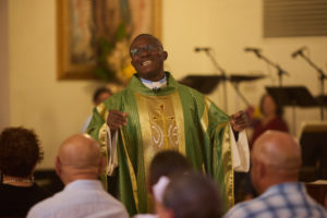 Father Chidi Ekpendu, pastor at St. Francis of Assisi Church in Silver Lake, smiles during the homily of a special Mass on Oct. 4 in a weekend of special events marking the 800th anniversary of St. Francis’ death in 1226. (John Geronilla)